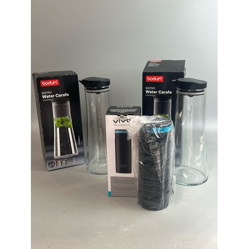 32 - Two boxed Bodum water carafes' with a boxed Vivo drinking bottle with tea infuser, all appear to be ... 