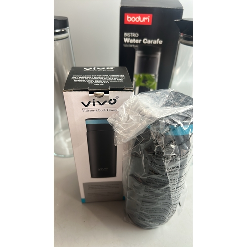 32 - Two boxed Bodum water carafes' with a boxed Vivo drinking bottle with tea infuser, all appear to be ... 