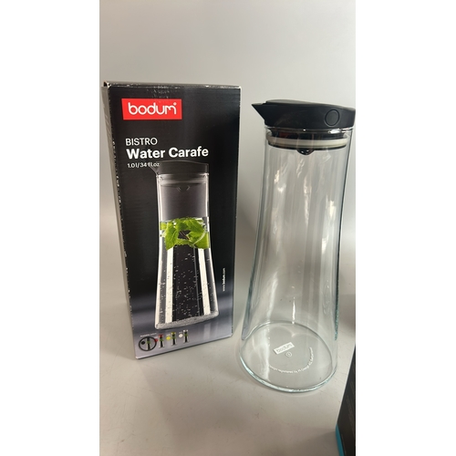 32 - Two boxed Bodum water carafes' with a boxed Vivo drinking bottle with tea infuser, all appear to be ... 