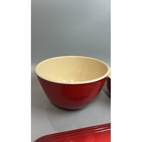 51 - Le Creuset ceramics including three mixing bowls, largest 27cm diameter, cheese board and one other ... 