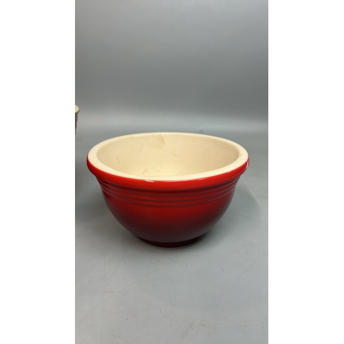 51 - Le Creuset ceramics including three mixing bowls, largest 27cm diameter, cheese board and one other ... 