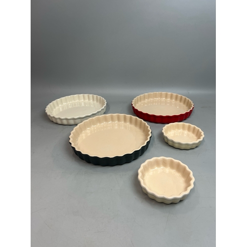 57 - Five Le Creuset flan dishes largest, 26cm diameter / T28