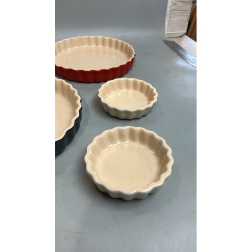 57 - Five Le Creuset flan dishes largest, 26cm diameter / T28