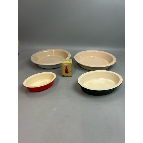 58 - Two large round Les Creuset pie dishes, 26cm diameter with two small oval dishes and a boxed pie fun... 