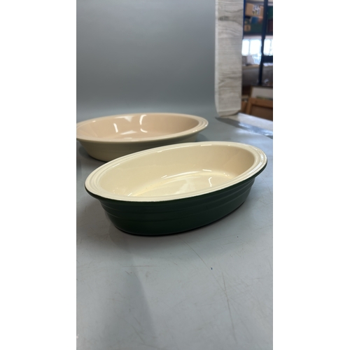 58 - Two large round Les Creuset pie dishes, 26cm diameter with two small oval dishes and a boxed pie fun... 