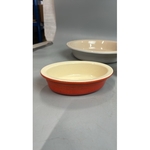 58 - Two large round Les Creuset pie dishes, 26cm diameter with two small oval dishes and a boxed pie fun... 