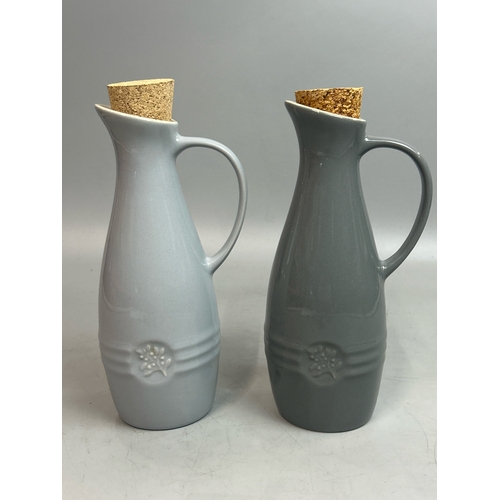 60 - Two Les Creuset oil carafes, 22.5cm high / T28