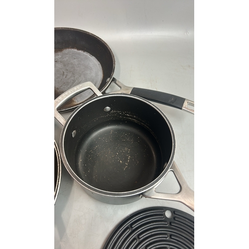 65 - Two Les Creuset frying pans and saucepan with two rubber mats / T29