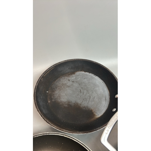 65 - Two Les Creuset frying pans and saucepan with two rubber mats / T29