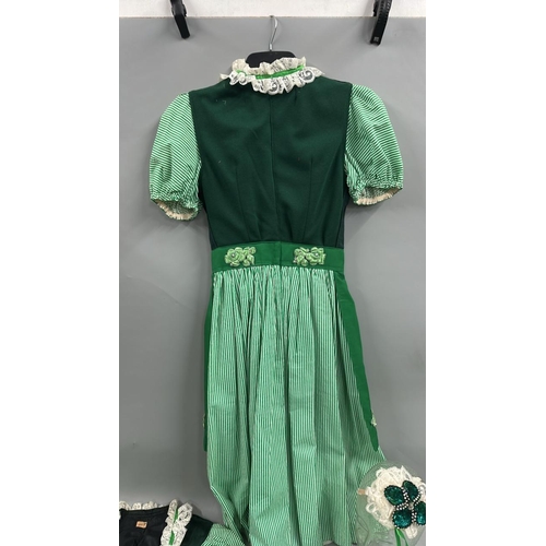 19 - Six typical 'Dirndl' style Bavarian dresses with three headdresses.