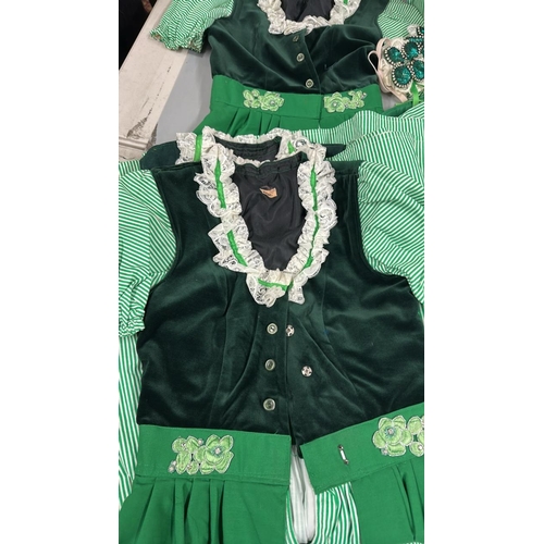 19 - Six typical 'Dirndl' style Bavarian dresses with three headdresses.