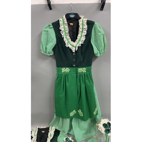 19 - Six typical 'Dirndl' style Bavarian dresses with three headdresses.