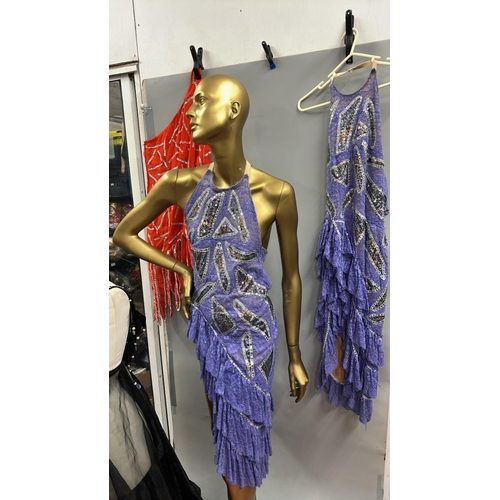 63 - Assorted stage worn garments including two purple frilly dresses, a black sequined bra top with shee... 