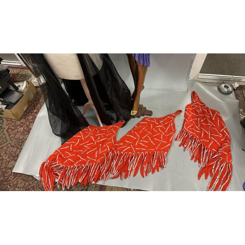 63 - Assorted stage worn garments including two purple frilly dresses, a black sequined bra top with shee... 