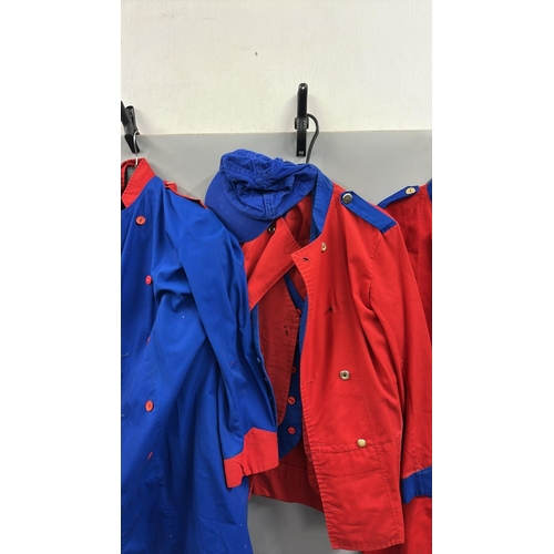 87 - A collection of 'stage worn' military style circus costume 3/4 length jackets, jackets, trousers and... 