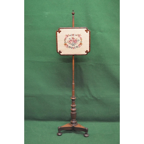 12 - Victorian mahogany pole screen having rectangular screen with shaped corners and embroidered with fl... 