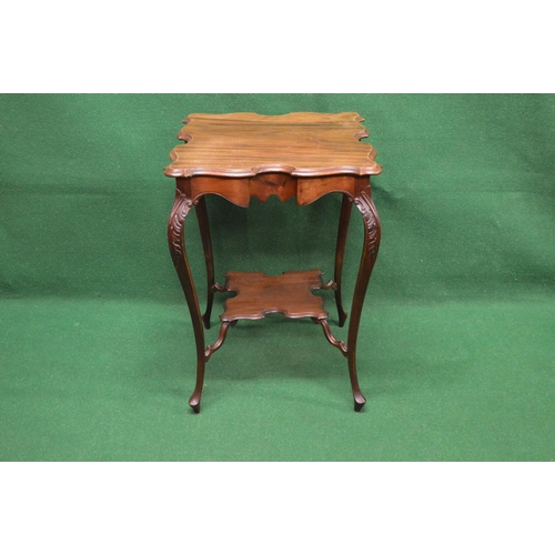 17 - Square mahogany two tier occasional table the top having shaped edges supported on carved cabriole s... 