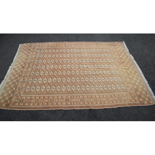 5 - Beige/brown ground rug having cream and black pattern with end tassels - 110'' x 77''