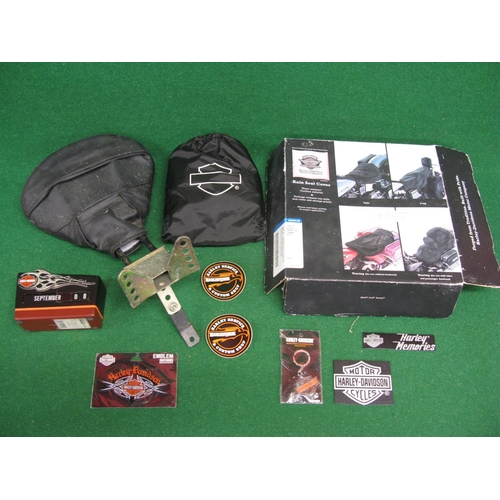 11 - Harley-Davidson boxed rain seat cover, desk calendar, key ring, logos and a second hand seat etc