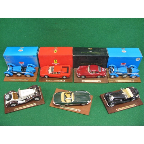 326 - Seven large scale metal and plastic Burago model sports cars mounted on display plinths, four are bo... 