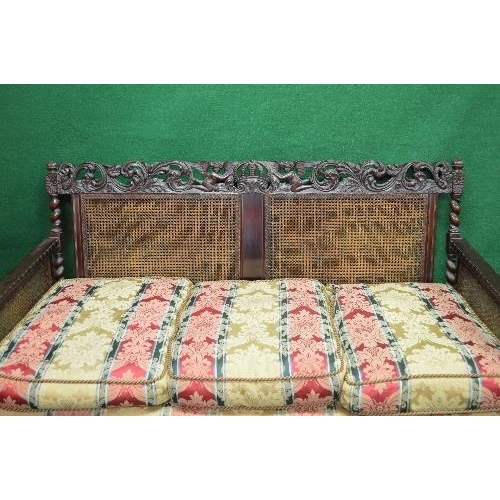 100 - Mahogany framed Bergere three piece suite having carved back rails over a caned back, solid arms bei... 