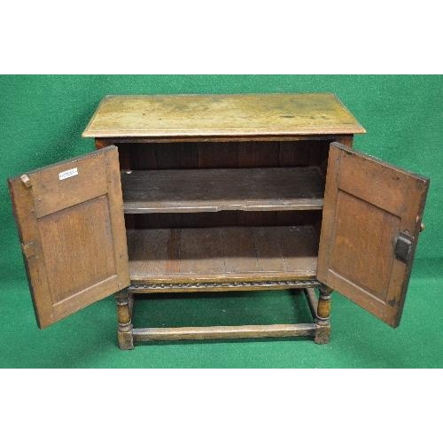 2 - 20th century oak Jacobean style side cabinet having two panelled doors and standing on stretchered l... 