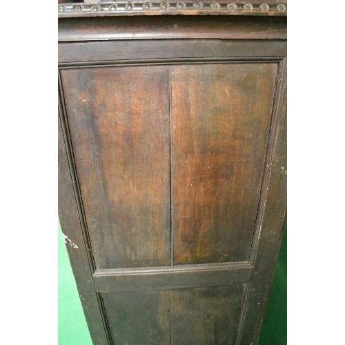 22 - Period oak buffet/court cupboard the top having heavily carved decoration with two panelled doors on... 