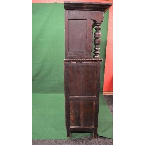 22 - Period oak buffet/court cupboard the top having heavily carved decoration with two panelled doors on... 