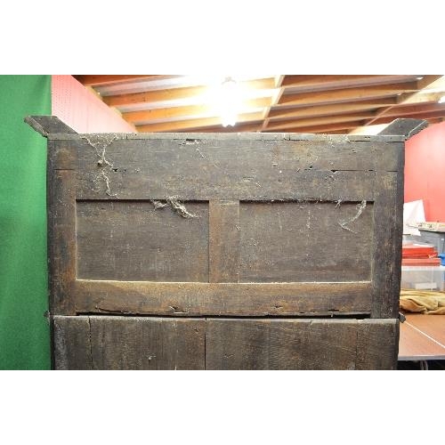 22 - Period oak buffet/court cupboard the top having heavily carved decoration with two panelled doors on... 