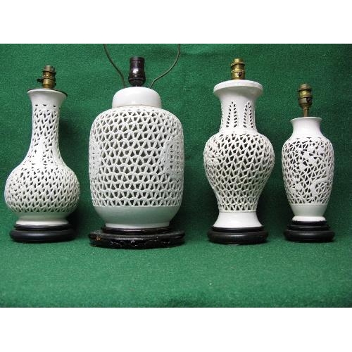 230 - Group of four Oriental white glazed reticulated lamps of various heights and forms