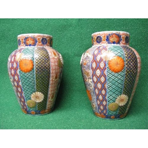 243 - Pair of Oriental bulbous ribbed vases having brightly coloured decorated panels and red back stamp -... 