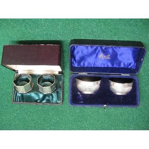 394 - Pair of boxed octagonal napkin rings together with a boxed pair of silver salts