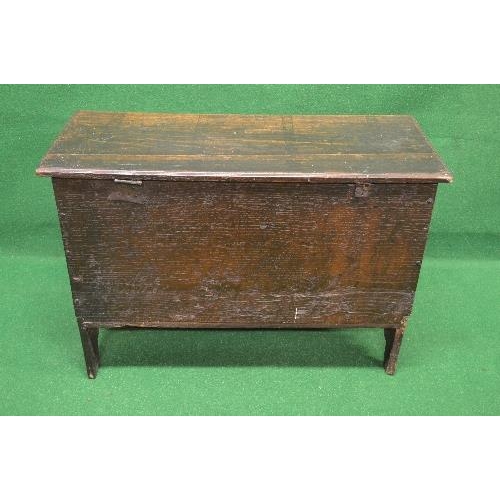 48 - Oak coffer the top lifting to reveal storage space and having light carved decoration, standing on V... 