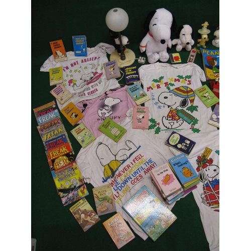 307 - Collection of Snoopy items to include: figures, lamp, t-shirts etc, paperbacks, boxed road racing ga... 