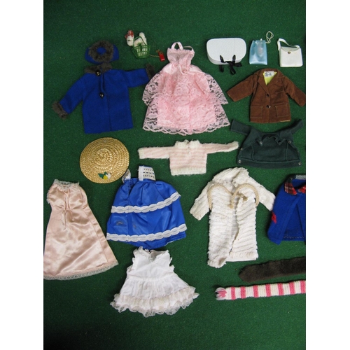 422 - Made in England Sindy doll with a selection of clothing and footwear (in the white case)