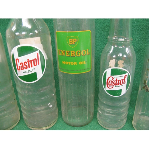 54 - Five oil bottles with three lids to include: Castrol and BP Energol