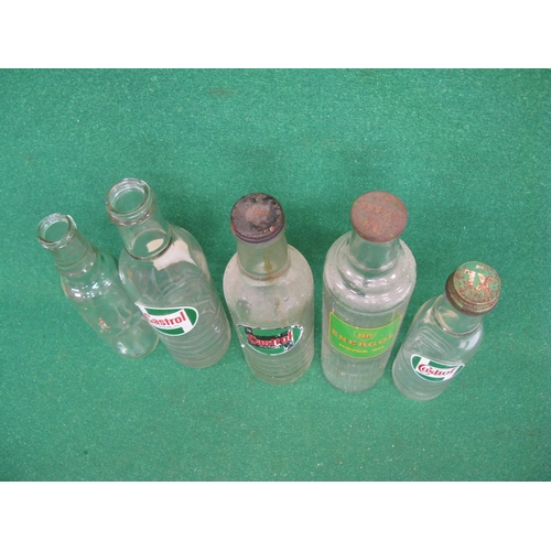 54 - Five oil bottles with three lids to include: Castrol and BP Energol