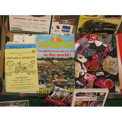 63 - Box of motoring ephemera to include: MG calendars, MG parts catalogues, show guides, auction catalog... 