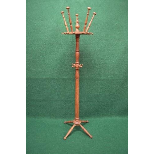 111 - Oak free standing coat stand having turned hat and coat hooks supported on a central turned column l... 