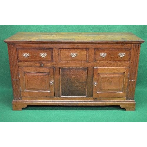 119 - 19th century oak dresser base having single central drawer flanked by single drawers with brass hand... 