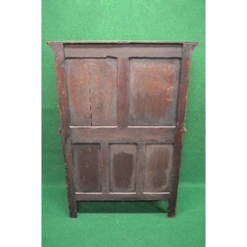 122 - Oak carved side cabinet having single panelled door carved with decoration of a figure opening to re... 