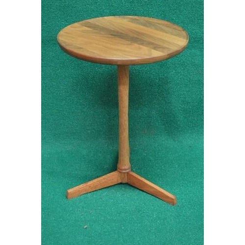 141 - Mid century wine table having circular top supported on a turned column leading to three moulded leg... 