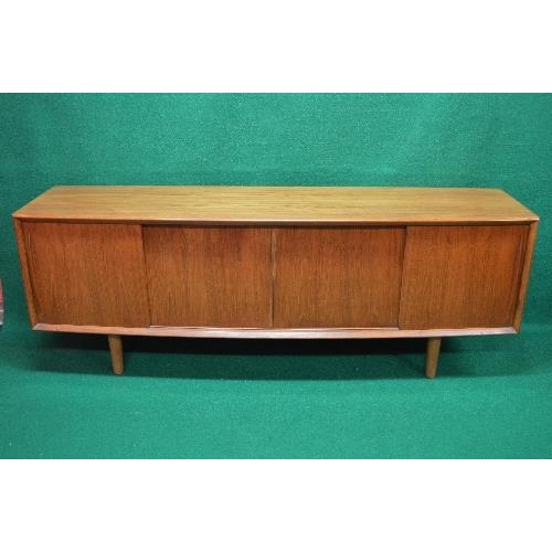 142 - Mid century Mobler Danish teak sideboard having bow front and four sliding doors opening to reveal a... 