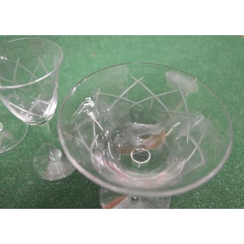 224 - Part suite of clear glass drinking glasses having a cut design to comprise: nineteen stemmed glasses... 