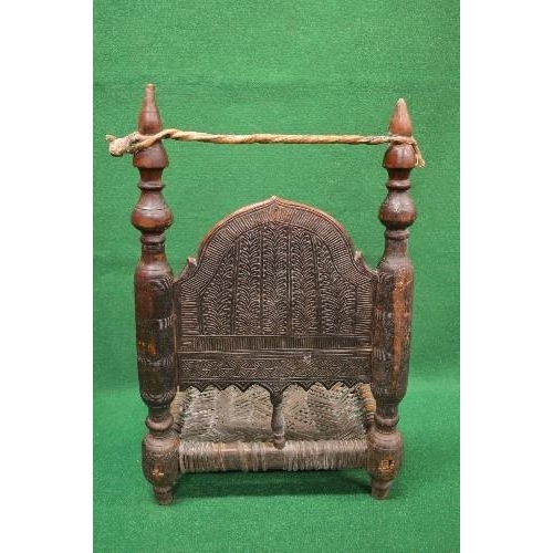 36 - Possibly Indian carved low seated chair having carved panelled back supported by turned columns lead... 