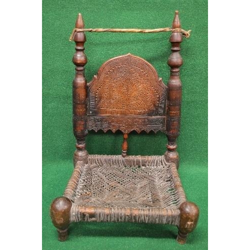 36 - Possibly Indian carved low seated chair having carved panelled back supported by turned columns lead... 