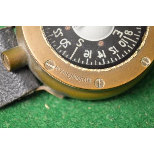 408 - Brass cased navigators compass having leather strap with brass clasp the compass case being marked 9... 