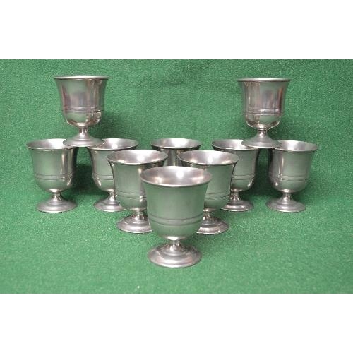 429 - Set of ten pewter goblets having fluted bowls supported on squat stemmed uprights leading to circula... 