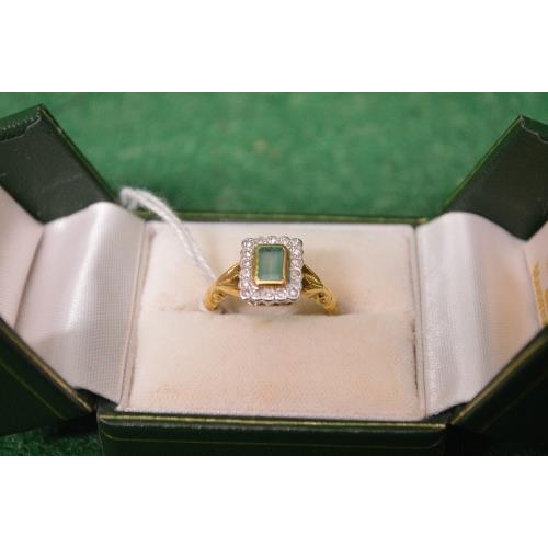 483 - 18ct yellow gold ladies ring having single rectangular emerald surmounted by a series of small diamo... 