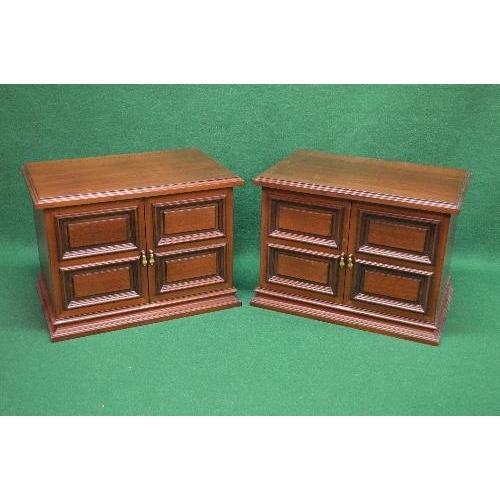 65 - Pair of mahogany side cabinets the tops having moulded edges over two cupboard doors with brass hand... 